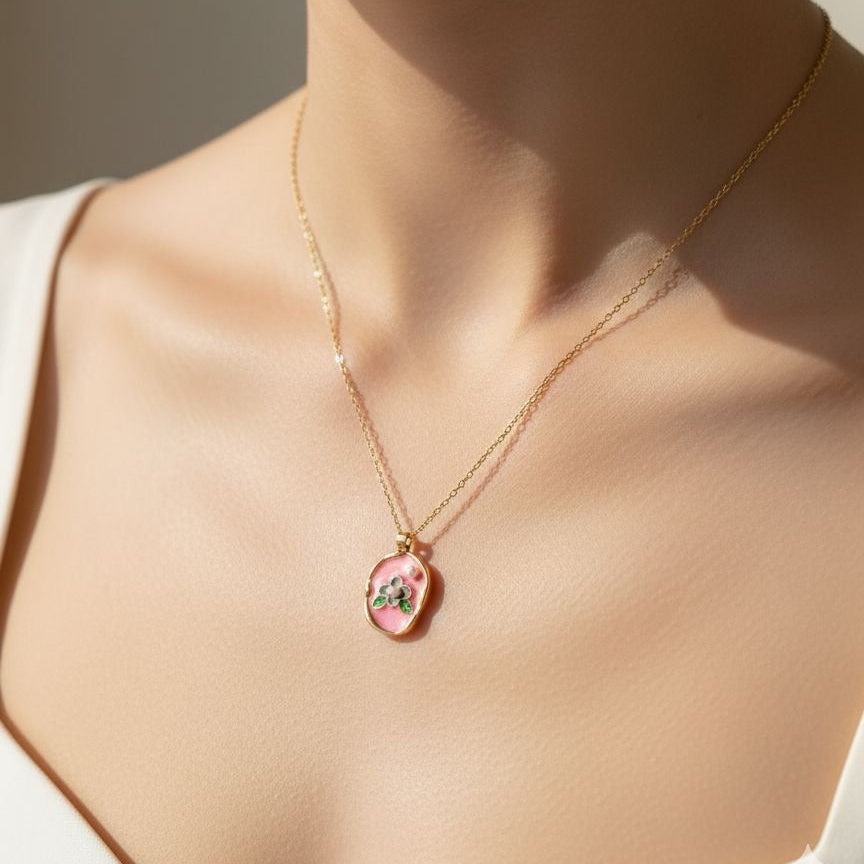 Necklace with a pendant on a person wearing a white top