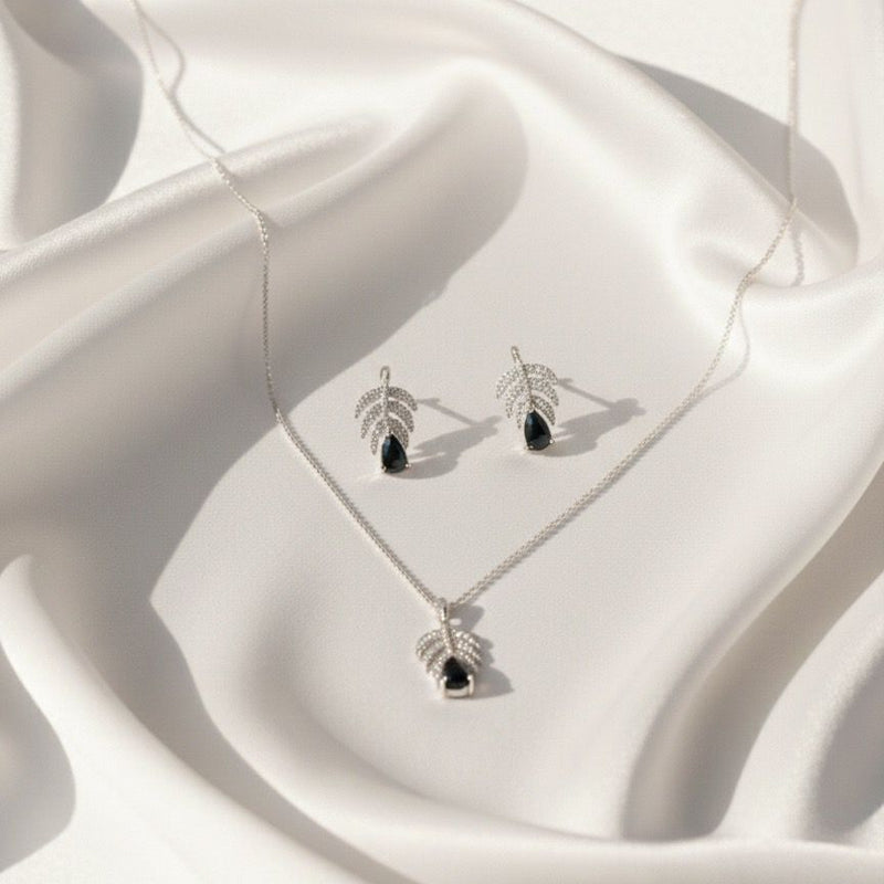 Jewelry set with necklace and earrings on a white fabric background