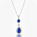 Silver necklace with blue teardrop-shaped gemstones on a white background