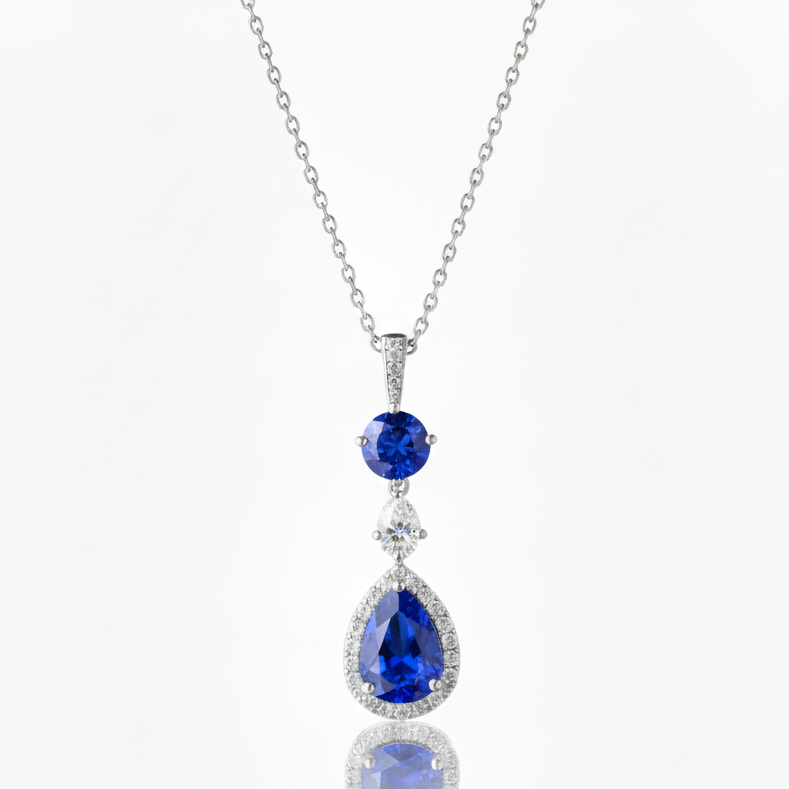 Silver necklace with blue teardrop-shaped gemstones on a white background