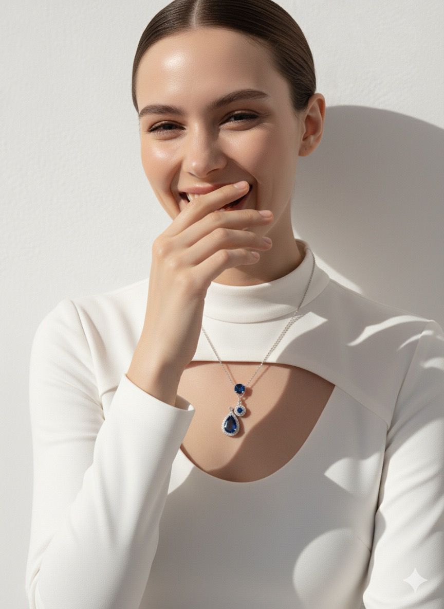 Woman wearing a necklace with a blue pendant against a neutral background