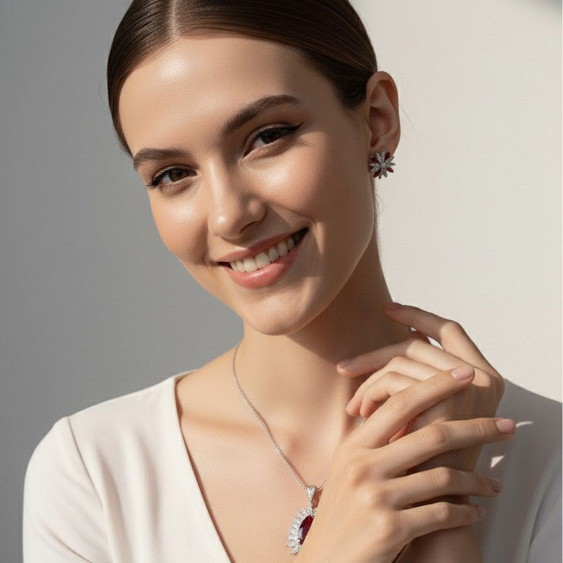 Woman wearing a necklace and earrings against a neutral background