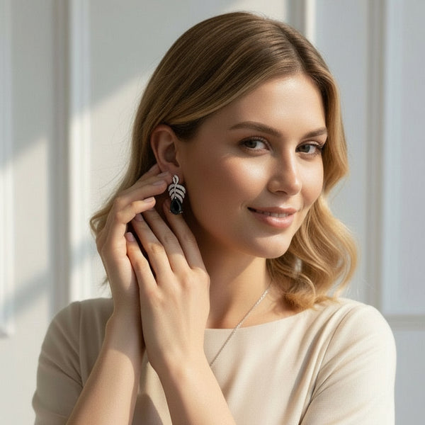 Woman adjusting earrings in a softly lit room