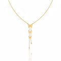 Gold butterfly necklace on a white background
