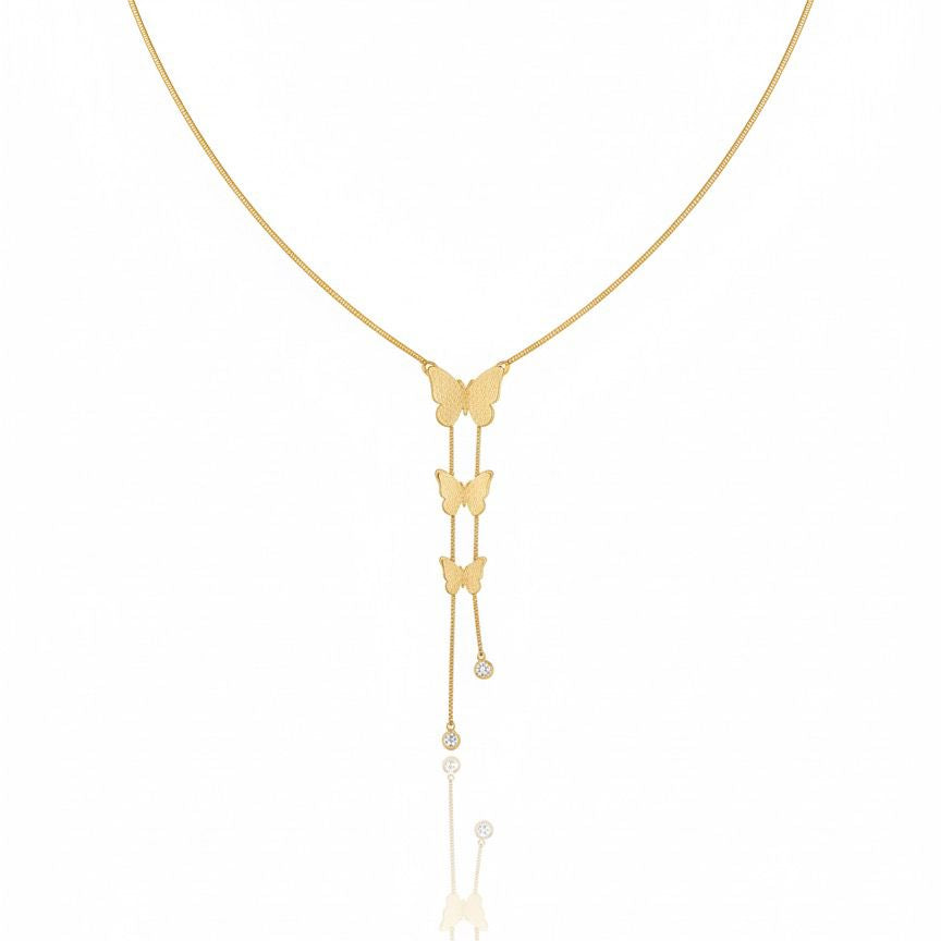 Gold butterfly necklace on a white background
