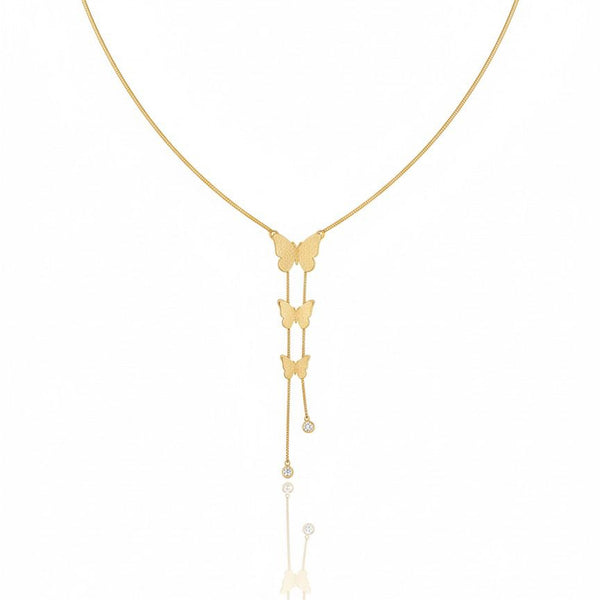 Gold butterfly necklace on a white background