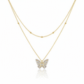 Gold butterfly necklace on a white background