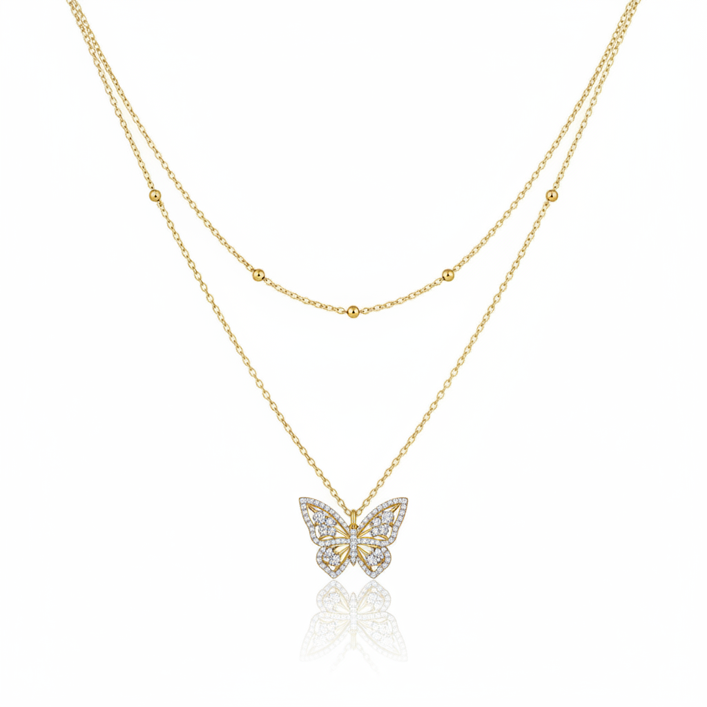 Gold butterfly necklace on a white background
