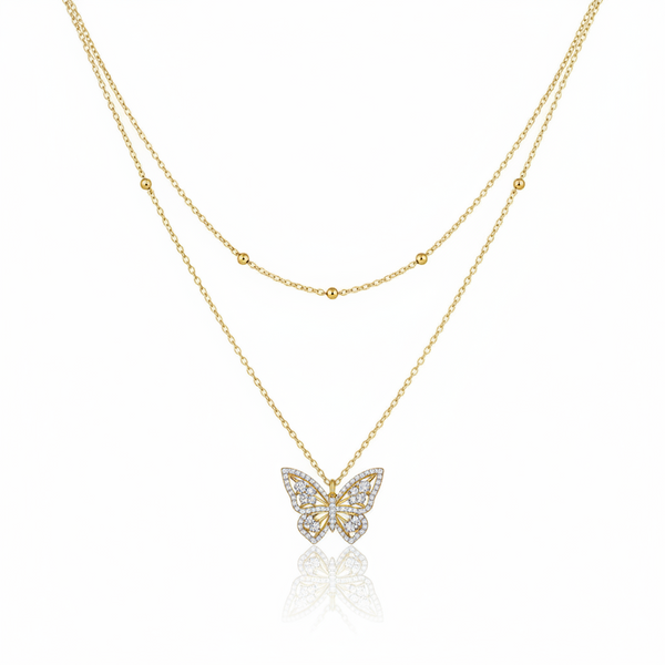 Gold butterfly necklace on a white background