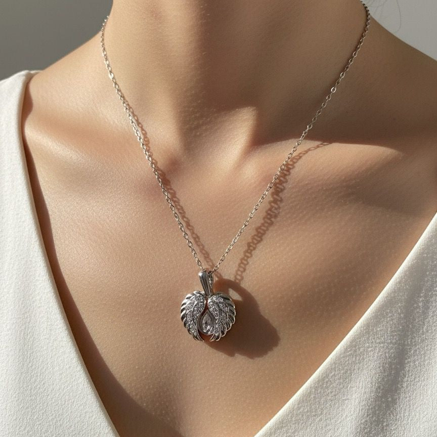 Necklace with a pendant worn by a person in a white top