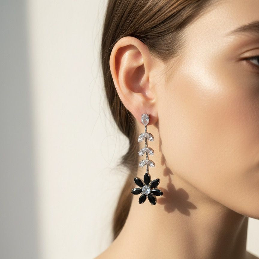 Close-up of a woman wearing a floral earring with a neutral background