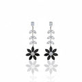 Pair of floral earrings with black and silver details on a white background