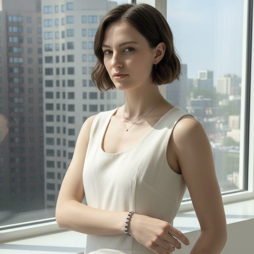 Woman in a white dress standing in front of a large window with cityscape view