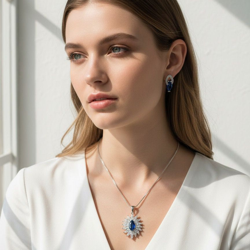 Woman wearing a necklace and earrings against a white background