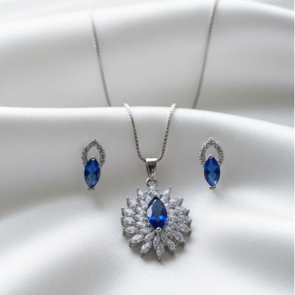 Silver jewelry set with blue stones on a white background