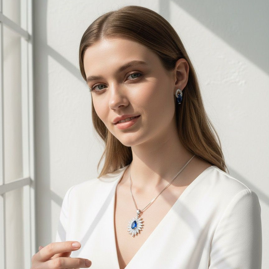 Woman wearing a white outfit with jewelry against a light background