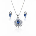 Jewelry set with necklace and earrings featuring blue stones on a white background