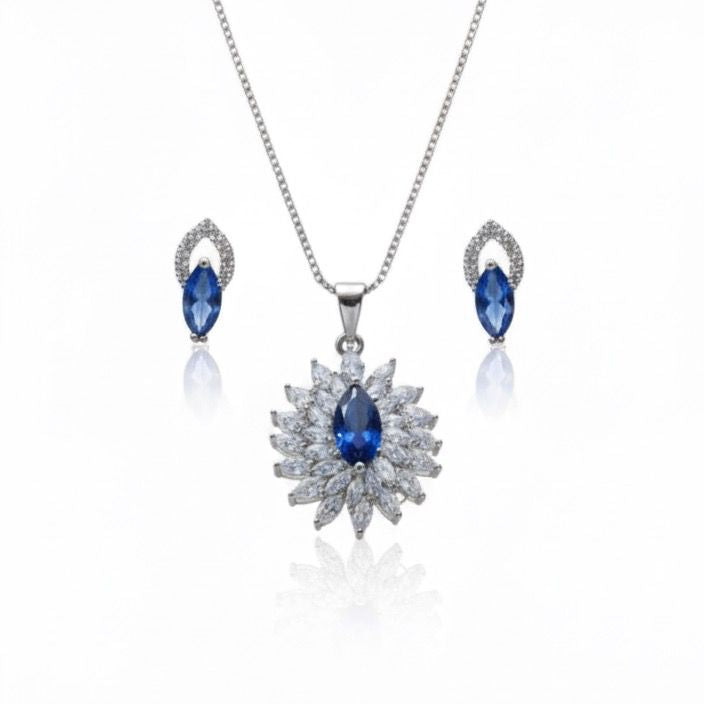 Jewelry set with necklace and earrings featuring blue stones on a white background