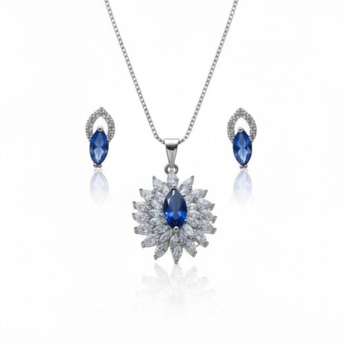 Jewelry set with necklace and earrings featuring blue stones on a white background