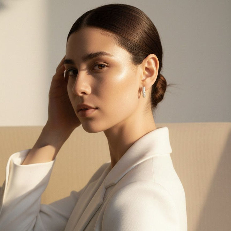 Woman wearing a white blazer with a neutral background