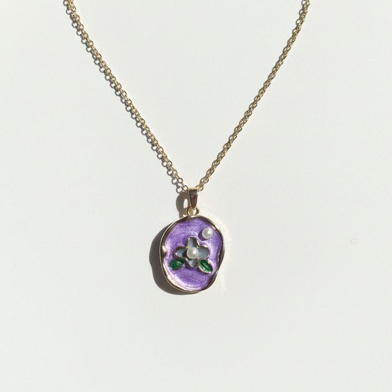 Necklace with a purple pendant on a white background