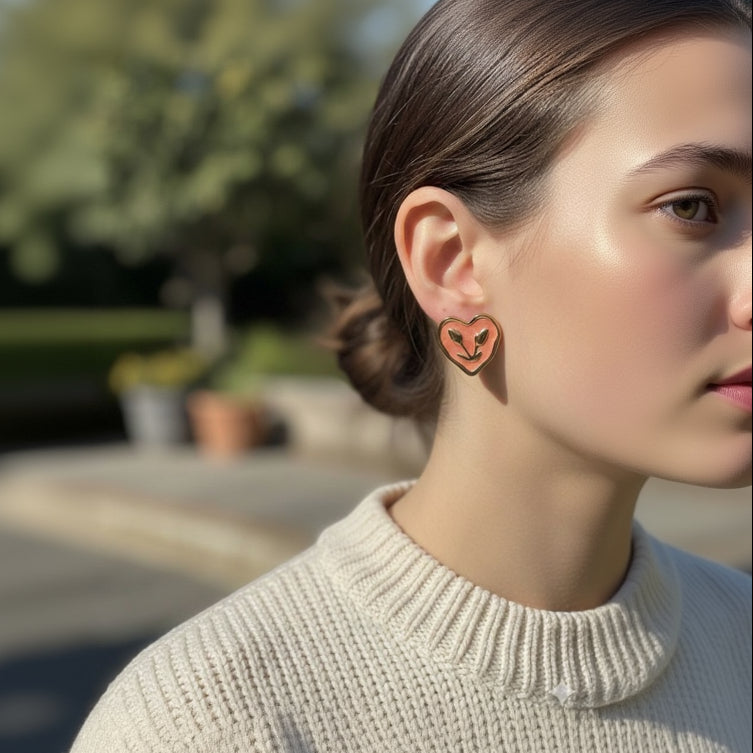Person wearing heart-shaped earrings with a blurred outdoor background