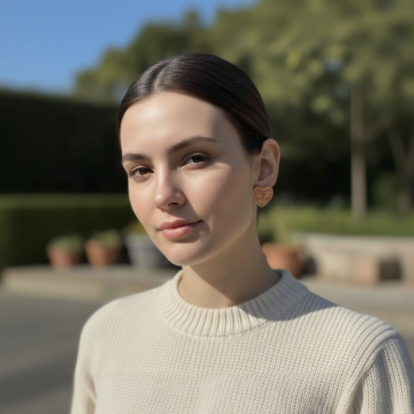 Woman wearing a beige sweater with a blurred outdoor background