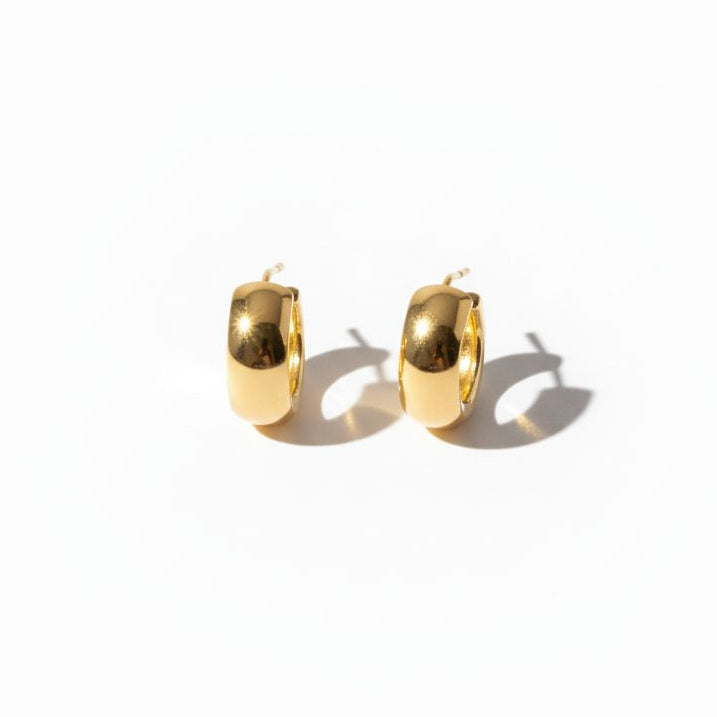 Gold hoop earrings on a white background