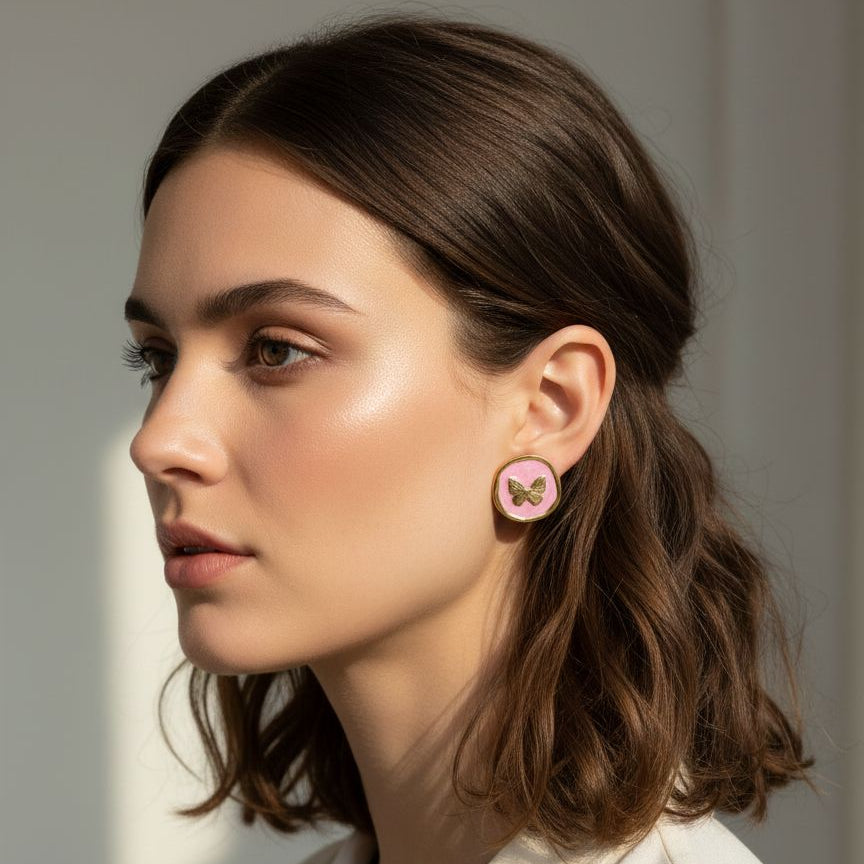 Woman wearing pink earrings with floral design against a neutral background