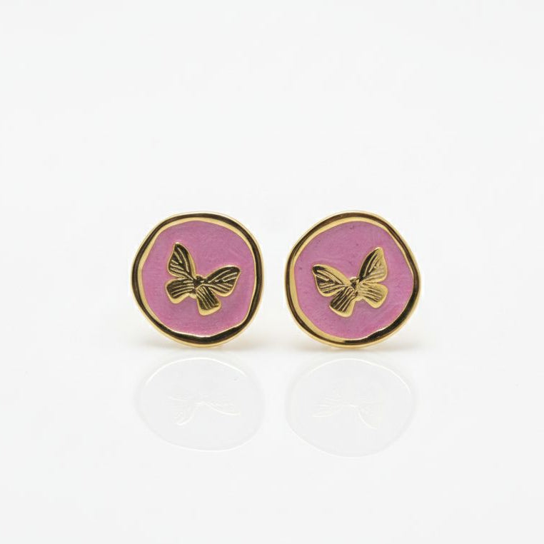 Pair of round earrings with butterfly design on a white background