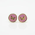 Pair of round earrings with butterfly design on a white background