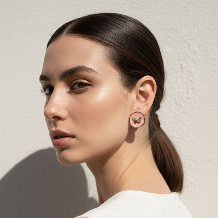 Woman wearing a pink earring against a neutral background