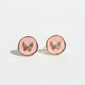 Pair of round earrings with butterfly design on a white background
