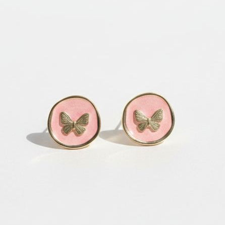 Pair of round earrings with butterfly design on a white background