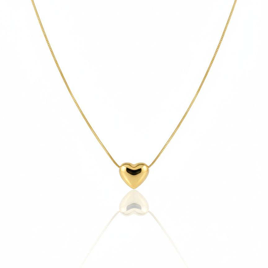 Gold heart-shaped pendant necklace on a white background