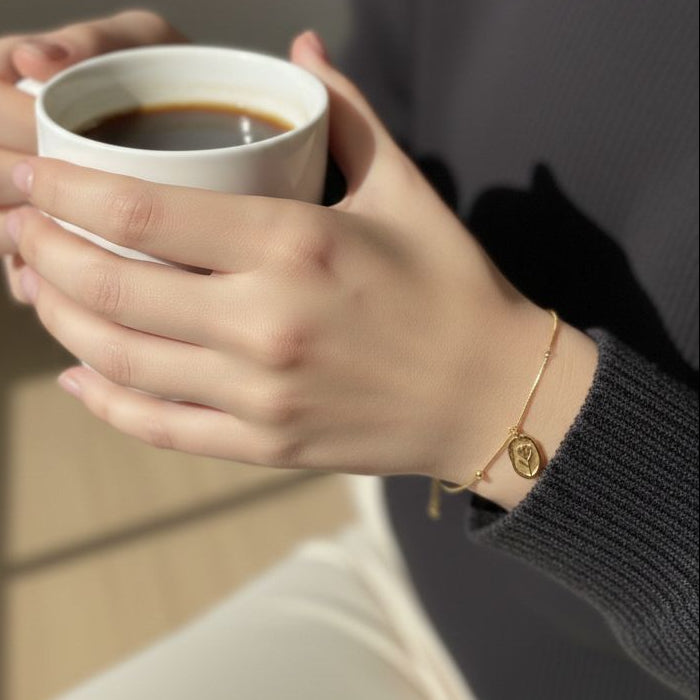 Person holding a white mug with coffee against a neutral background
