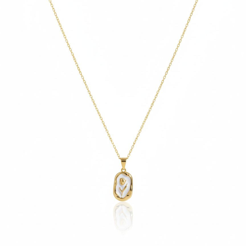 Gold necklace with a pendant on a white background