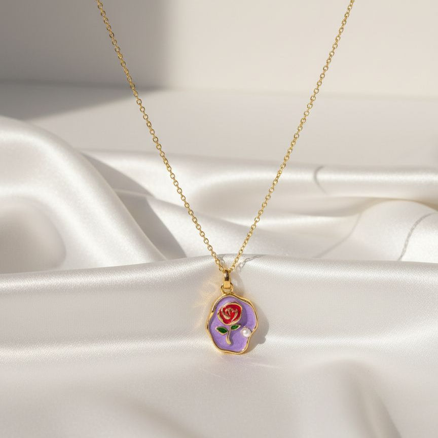 Necklace with a pendant featuring a rose design on a white fabric background