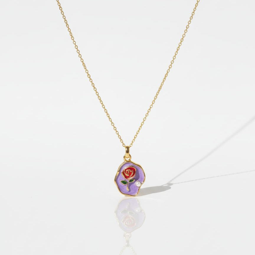 Necklace with a purple pendant featuring a rose on a white background