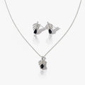 Silver necklace and earrings with black stones on a white background